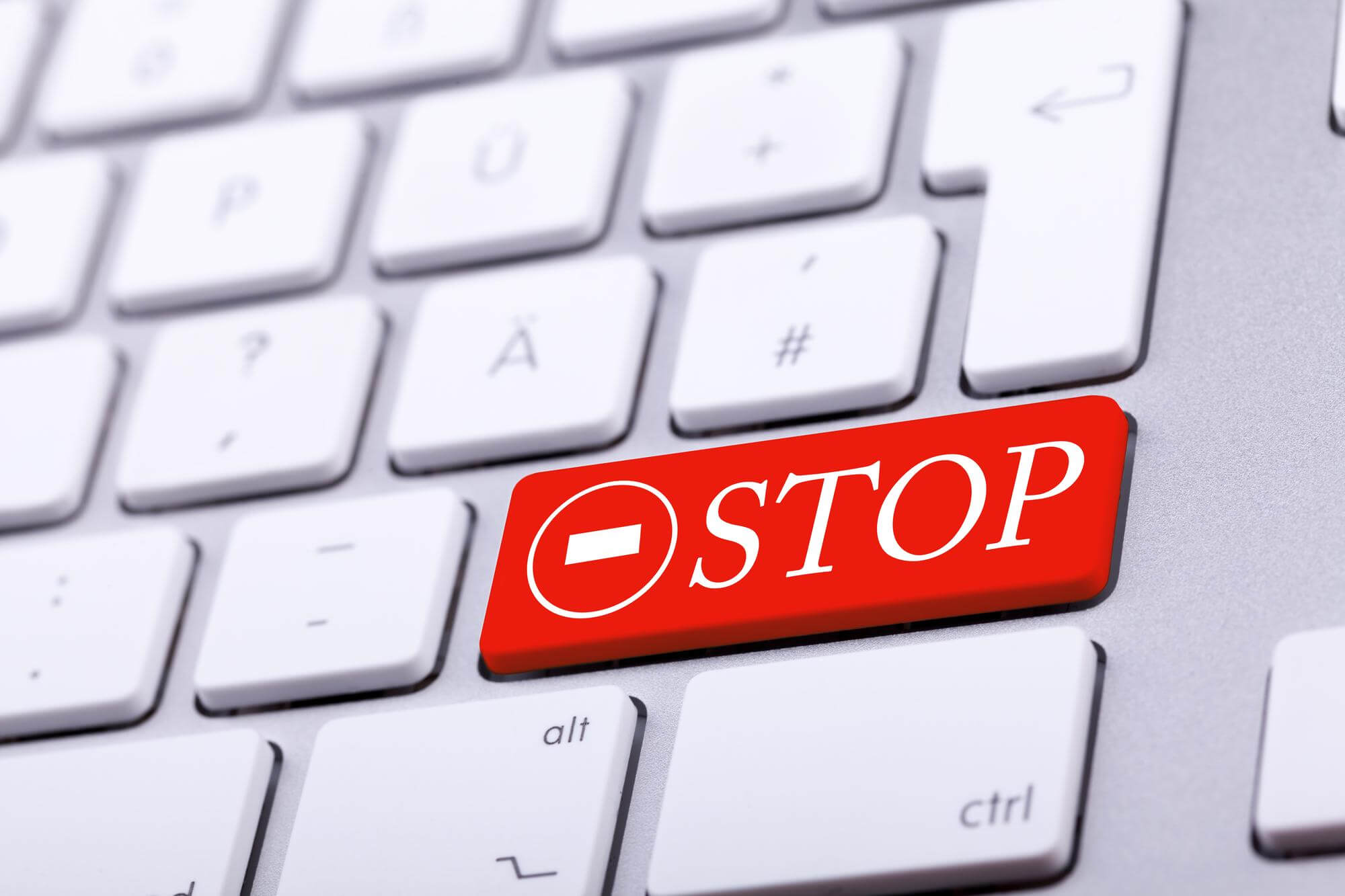 aluminium keyboard with stop word sign red studio photo standard keyboard close up shooting with blurred background alert